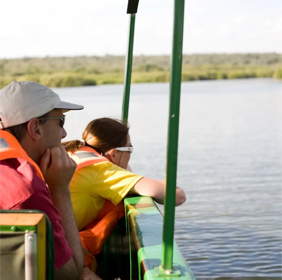 Visitors in life jackets on a boat safari on Lake Mburo