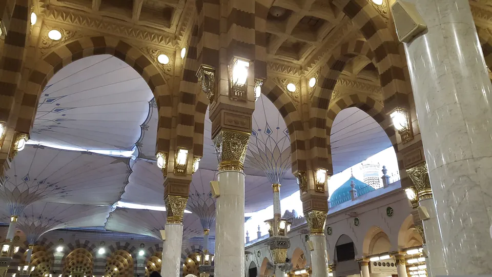 Inside Masjid an-Nabawi in Madinah, beneath its columns and canopies