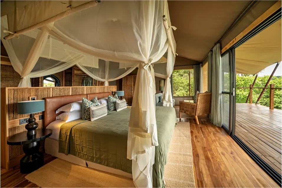 The interior of a tented safari suite in Uganda, opening onto a private deck